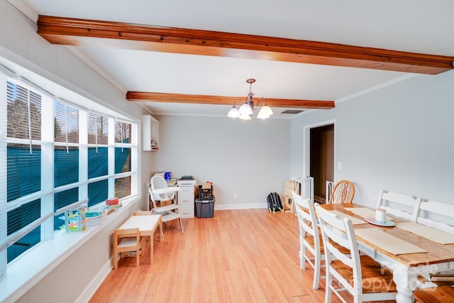 dining space featuring baseboards, an inviting chandelier, beam ceiling, light wood-style flooring, and crown molding