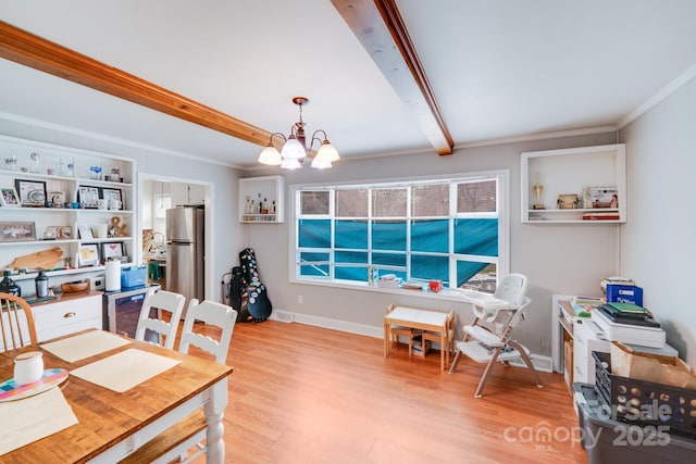 dining area featuring beamed ceiling, light wood-style flooring, ornamental molding, an inviting chandelier, and baseboards