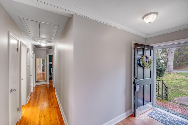 entryway with light wood finished floors and baseboards