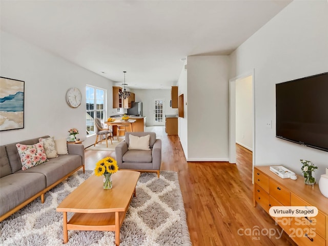 living room featuring light wood-type flooring and baseboards