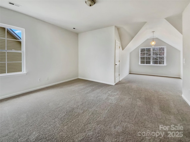 bonus room featuring carpet floors, lofted ceiling, visible vents, and baseboards