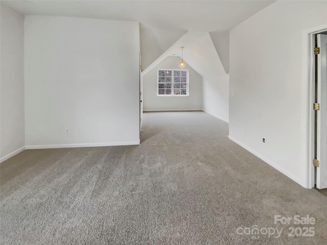 bonus room with lofted ceiling, carpet floors, and baseboards