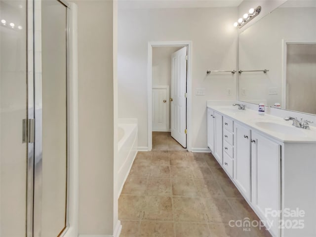 bathroom featuring double vanity, a garden tub, and a shower stall