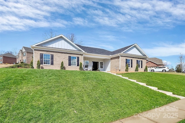 ranch-style house with board and batten siding, a front yard, and brick siding