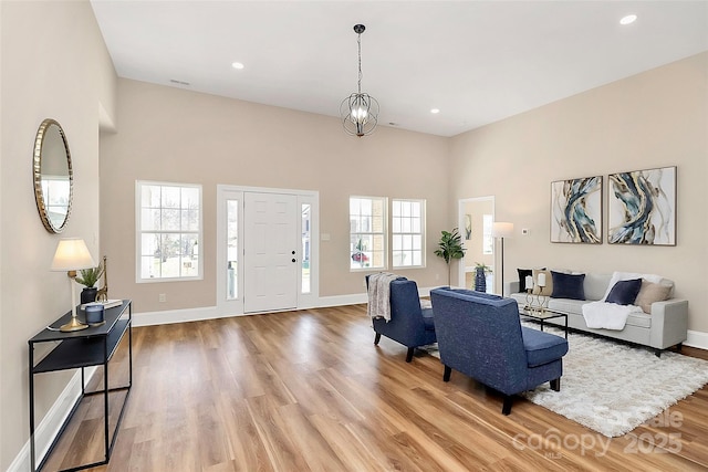 living area featuring light wood finished floors, recessed lighting, and baseboards