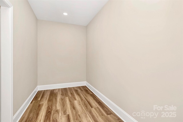 unfurnished room with recessed lighting, baseboards, and wood finished floors