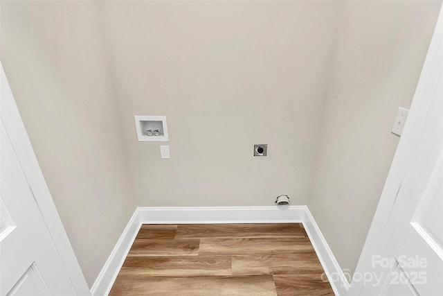 washroom featuring laundry area, baseboards, wood finished floors, hookup for an electric dryer, and washer hookup