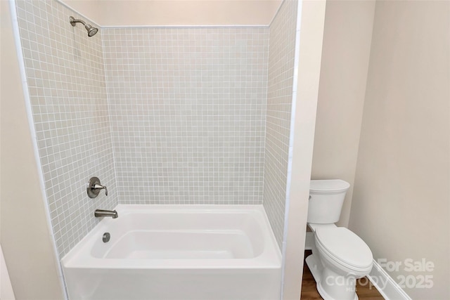 bathroom with toilet and  shower combination