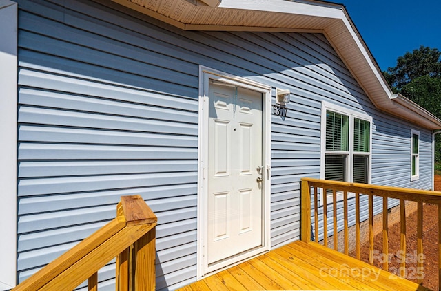 view of exterior entry with a wooden deck