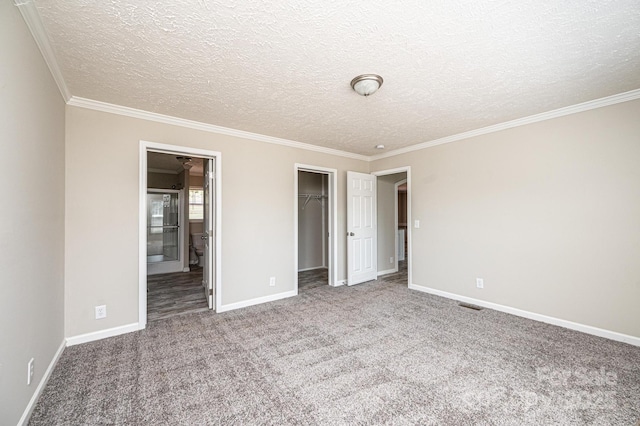 unfurnished bedroom featuring carpet floors, a spacious closet, baseboards, and a closet