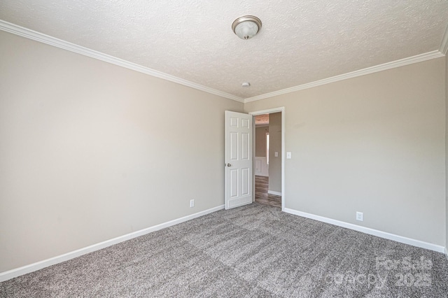 carpeted empty room with ornamental molding, a textured ceiling, and baseboards