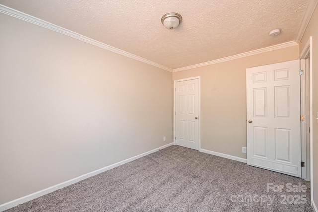 carpeted empty room featuring baseboards, a textured ceiling, and ornamental molding