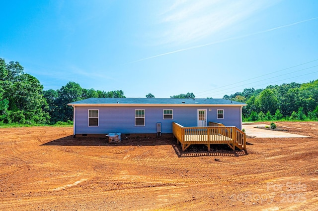 rear view of property with crawl space and a wooden deck