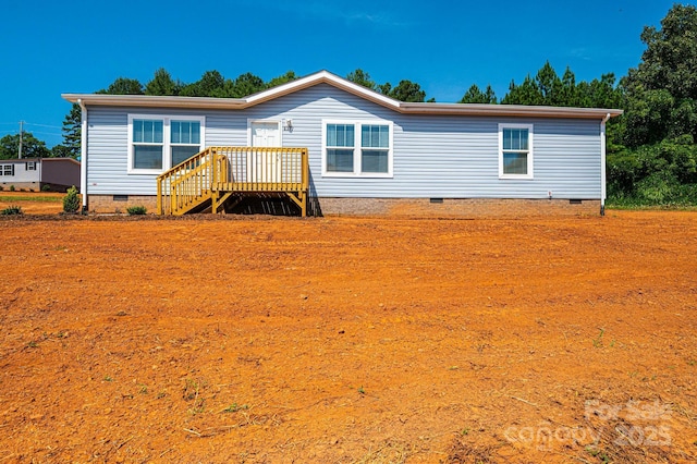 rear view of house with crawl space