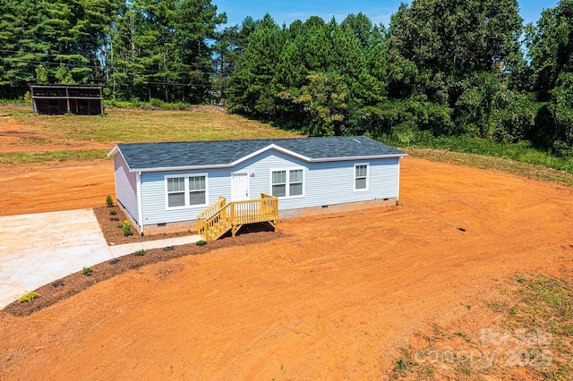 manufactured / mobile home with crawl space and roof with shingles