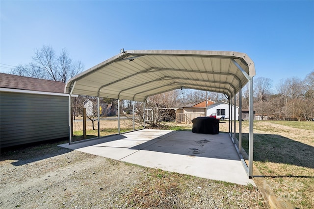 view of car parking featuring a detached carport and fence