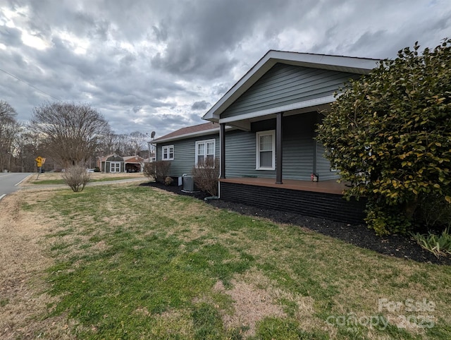 view of property exterior featuring a yard and central air condition unit