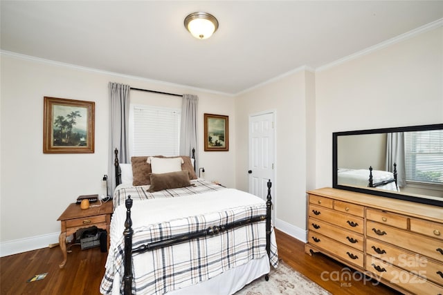 bedroom featuring crown molding, wood finished floors, and baseboards