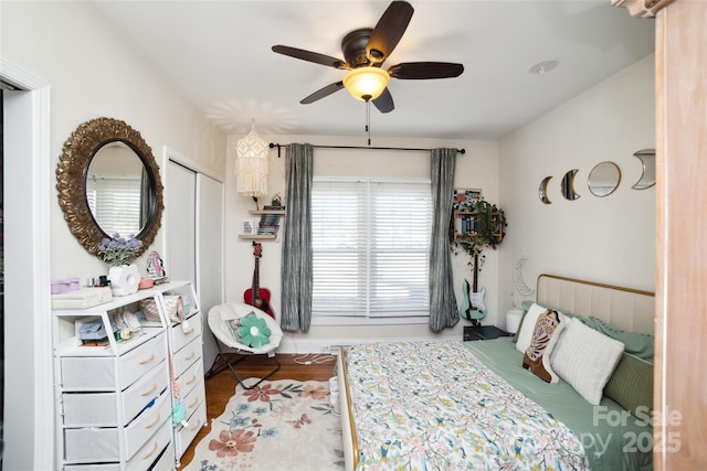 bedroom featuring wood finished floors and a ceiling fan