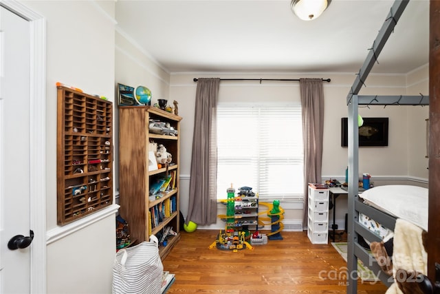 interior space featuring ornamental molding and wood finished floors