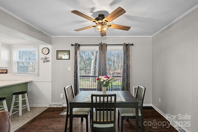 dining room featuring a textured ceiling, plenty of natural light, and visible vents