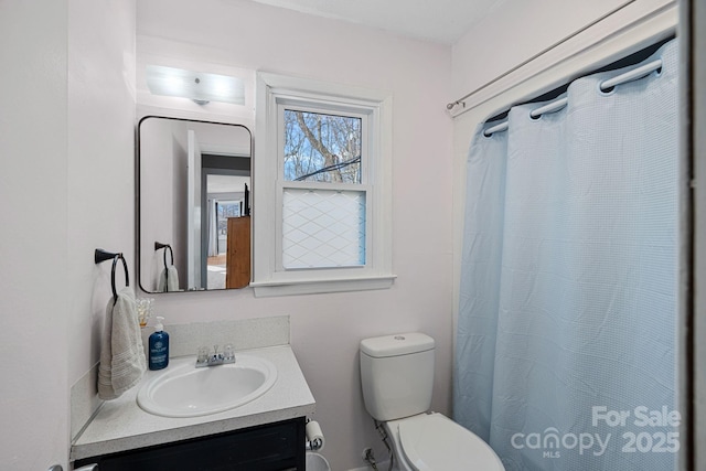 full bath featuring curtained shower, vanity, and toilet