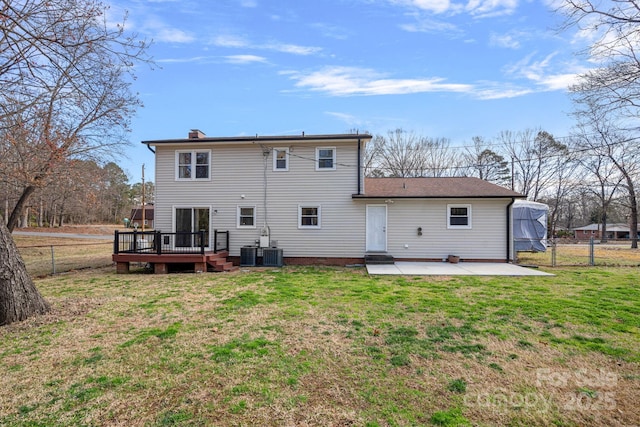 rear view of property with a deck, a yard, a patio area, and a fenced backyard