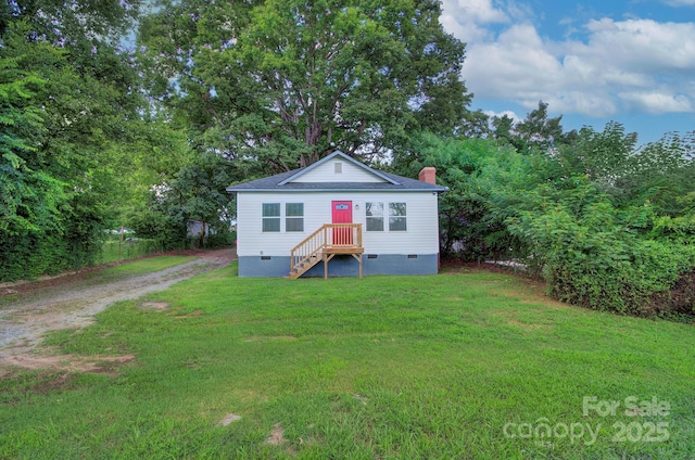 view of front of house featuring crawl space, dirt driveway, a chimney, and a front yard