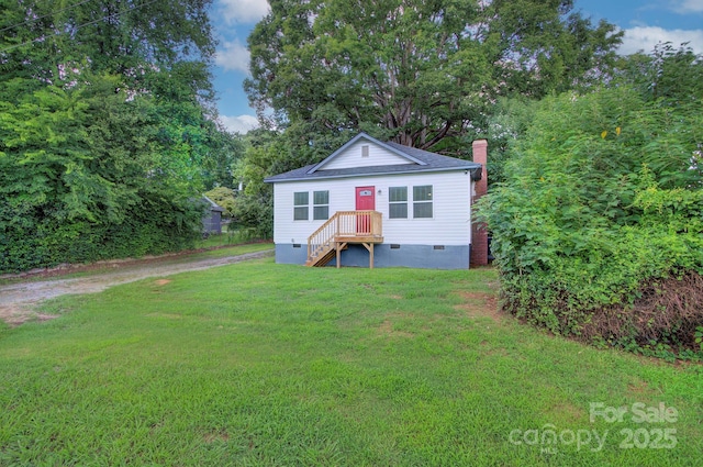 view of front of home featuring crawl space, dirt driveway, a chimney, and a front yard