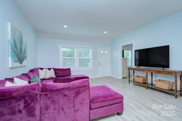 living room with recessed lighting, baseboards, and wood finished floors