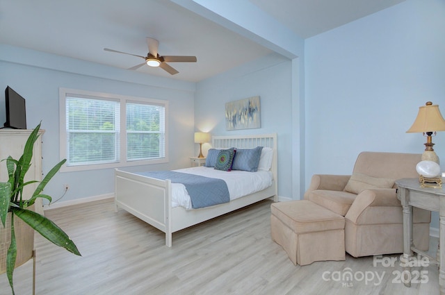 bedroom with ceiling fan, baseboards, and wood finished floors