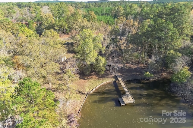 bird's eye view featuring a wooded view