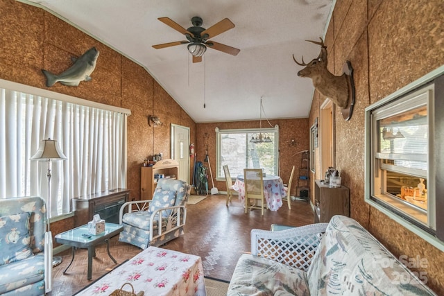 living area featuring vaulted ceiling and ceiling fan