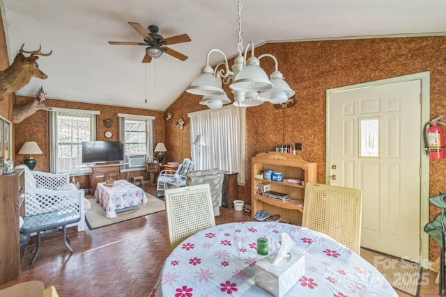 dining room with vaulted ceiling and ceiling fan with notable chandelier