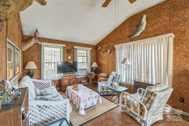 living room with a ceiling fan and vaulted ceiling