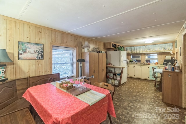 dining room featuring wood walls