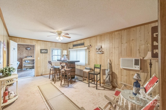 carpeted dining space featuring ornamental molding, wood walls, and a textured ceiling