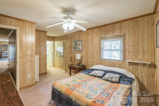 carpeted bedroom featuring wooden walls, cooling unit, crown molding, and a textured ceiling