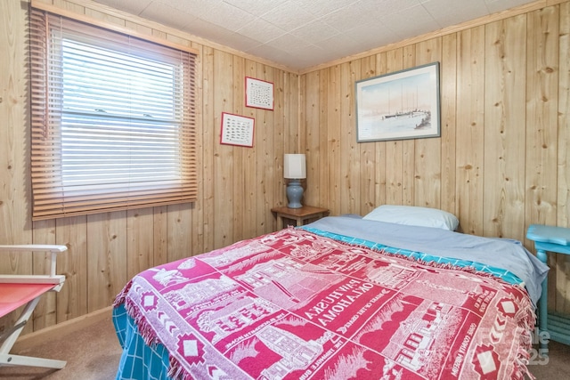 bedroom featuring wooden walls and carpet flooring