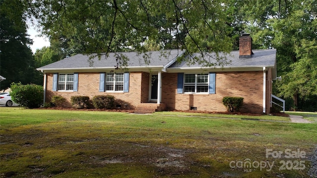 ranch-style house featuring a shingled roof, a chimney, a front lawn, crawl space, and brick siding