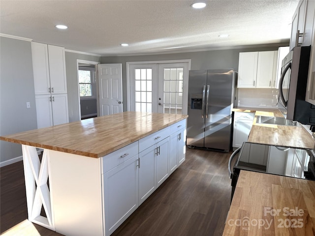 kitchen featuring wood counters, dark wood-style flooring, a center island, white cabinetry, and stainless steel refrigerator with ice dispenser