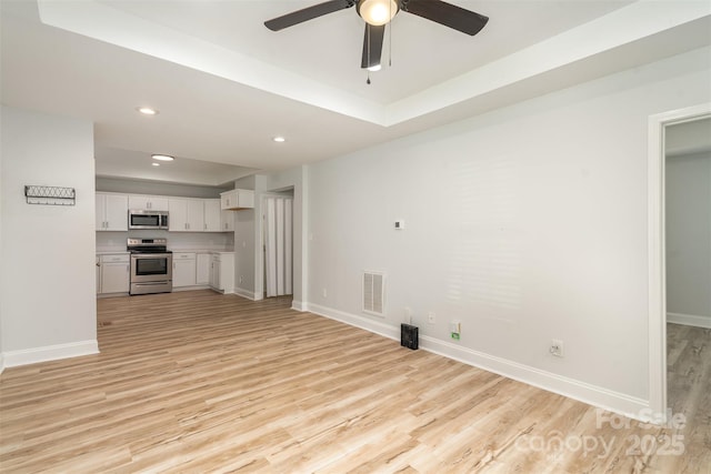 unfurnished living room featuring light wood-type flooring, baseboards, and visible vents