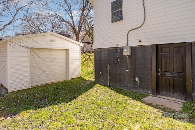 view of yard with an outbuilding, driveway, and a detached garage