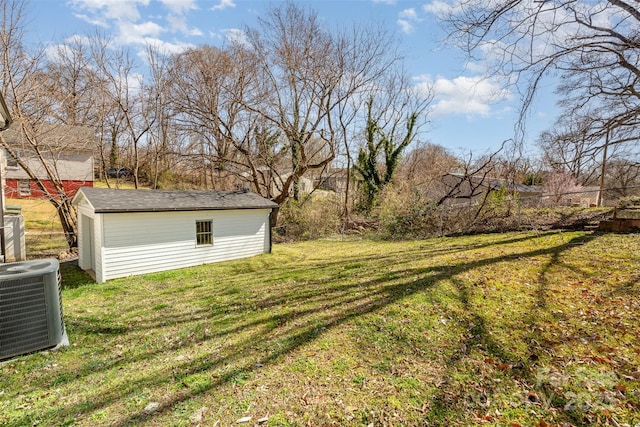 view of yard featuring an outbuilding, a shed, and central air condition unit