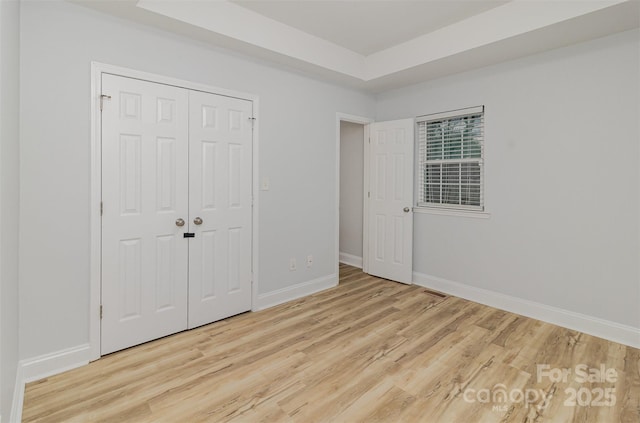 unfurnished bedroom with light wood finished floors and baseboards