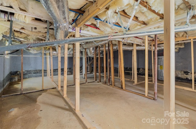 unfinished basement featuring water heater