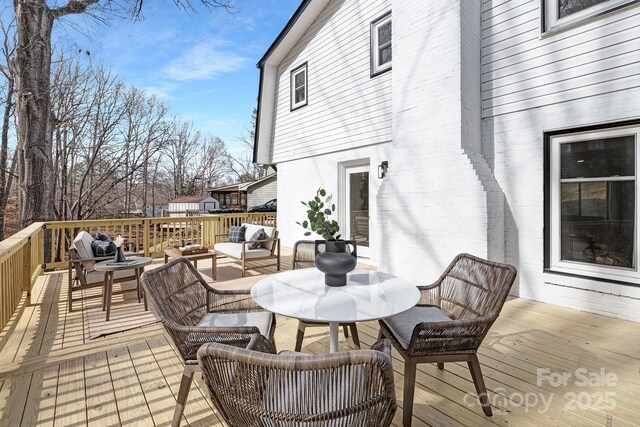 wooden deck featuring outdoor dining area and outdoor lounge area