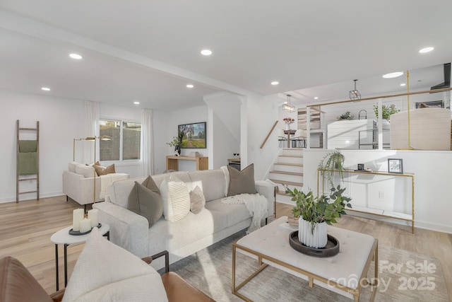 living area with baseboards, stairway, wood finished floors, and recessed lighting