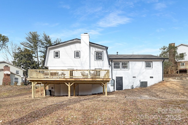 rear view of house with a deck, crawl space, a chimney, and central air condition unit