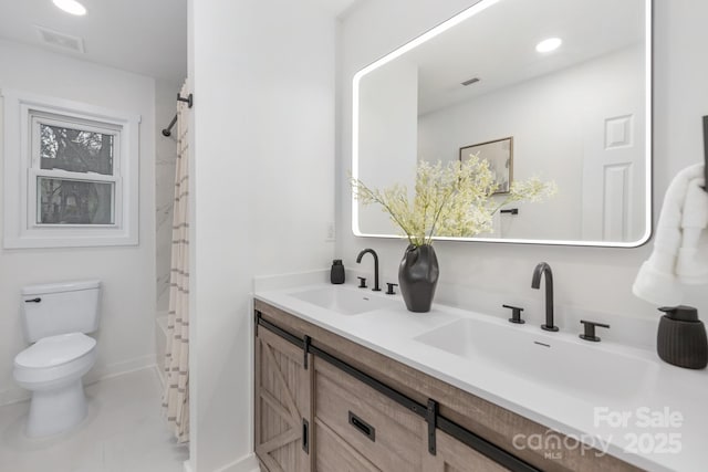 full bathroom featuring toilet, double vanity, visible vents, and a sink